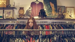 girl looking at clothes racks image