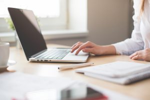 woman typing up routine on a laptop computer