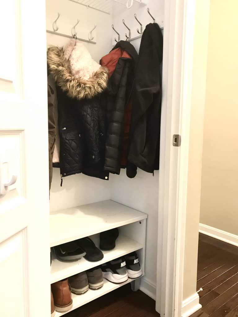 turning closet into mudroom with coats, hooks, and a shoe storage bench