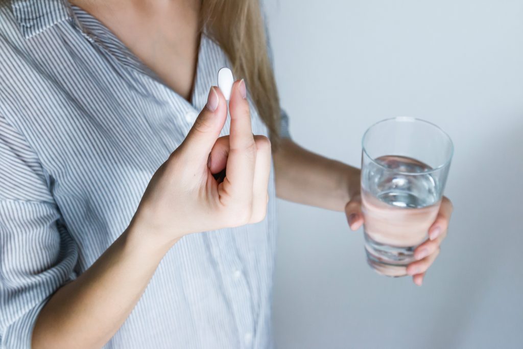 Mom taking medicine to get through a sick day with kids at home.  #sickday #mom #selfcare