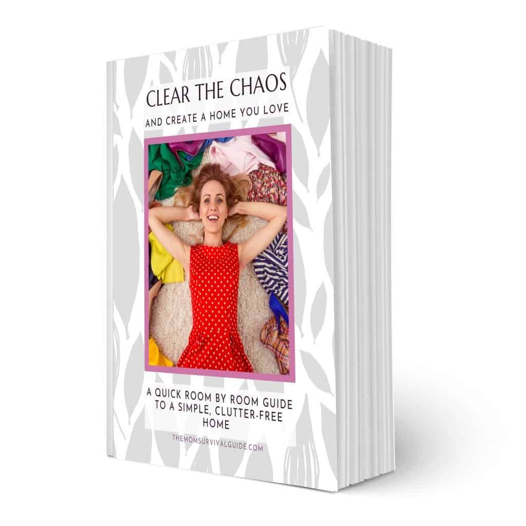 Picture of decluttering guide book with woman on front in red dress surrounded by clothes