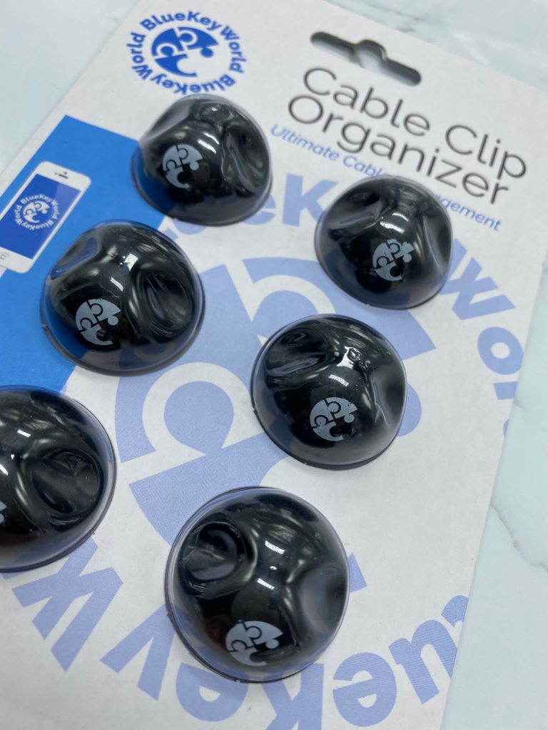 Close up picture of black wire holders in clear bubble packaging background blue and white