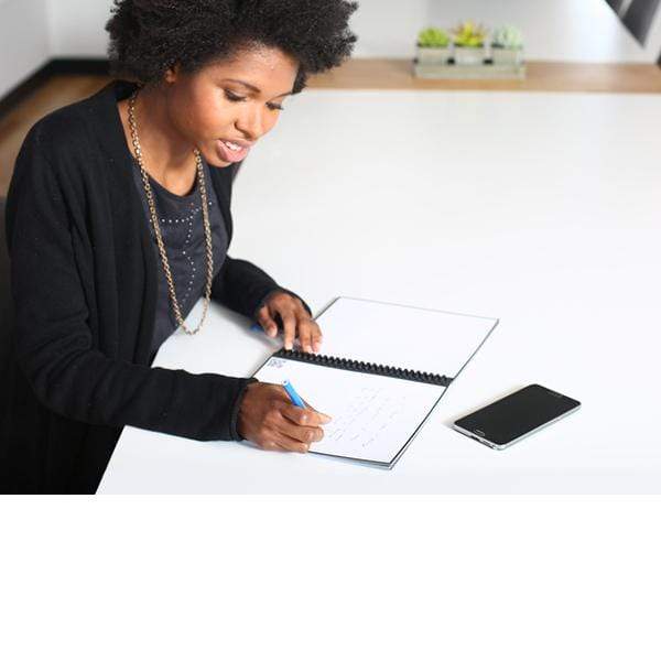 woman using rocketbook erasable notebook