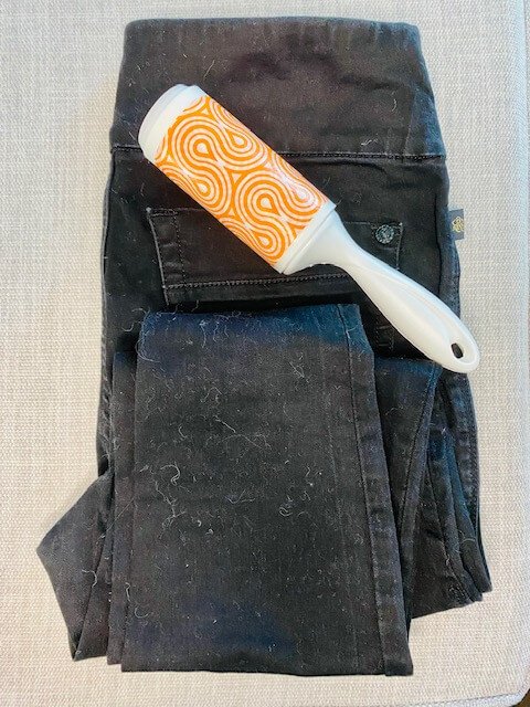 black pants with orange and white lint roller