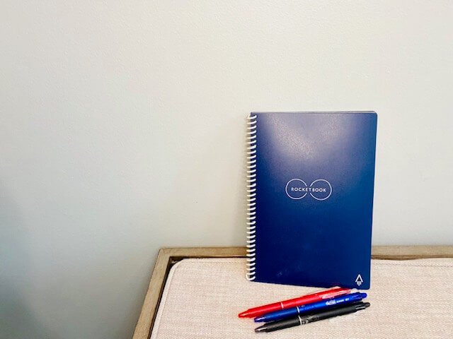 blue rocketbook digital notebook and 3 pens in red blue and black