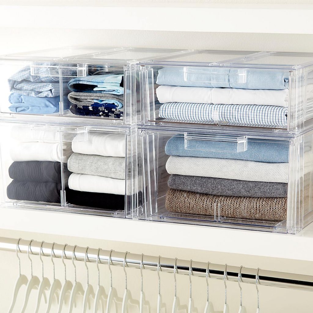 acrylic drawers with shirts and sweaters in a closet