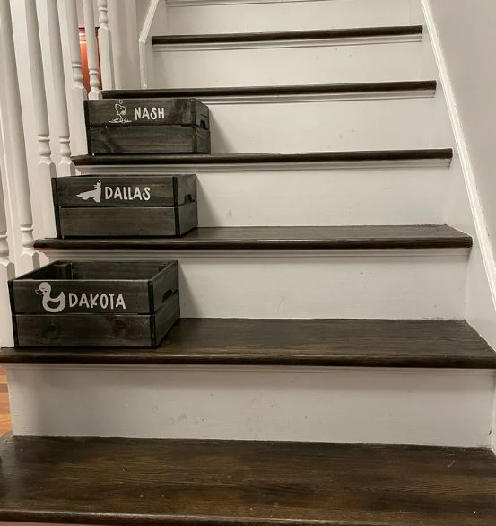 1 of 5 ways to organize messy stairs with personalized bins