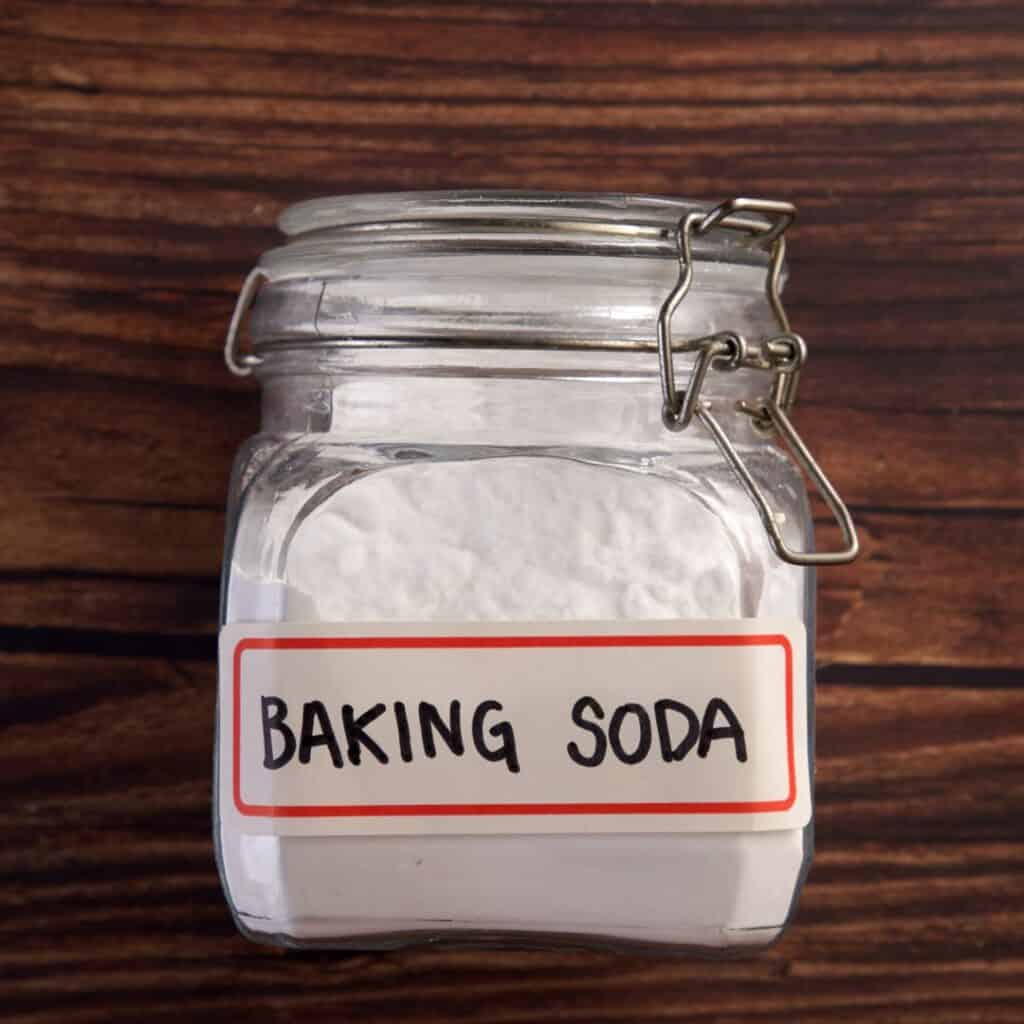 jar of baking soda on a wooden background